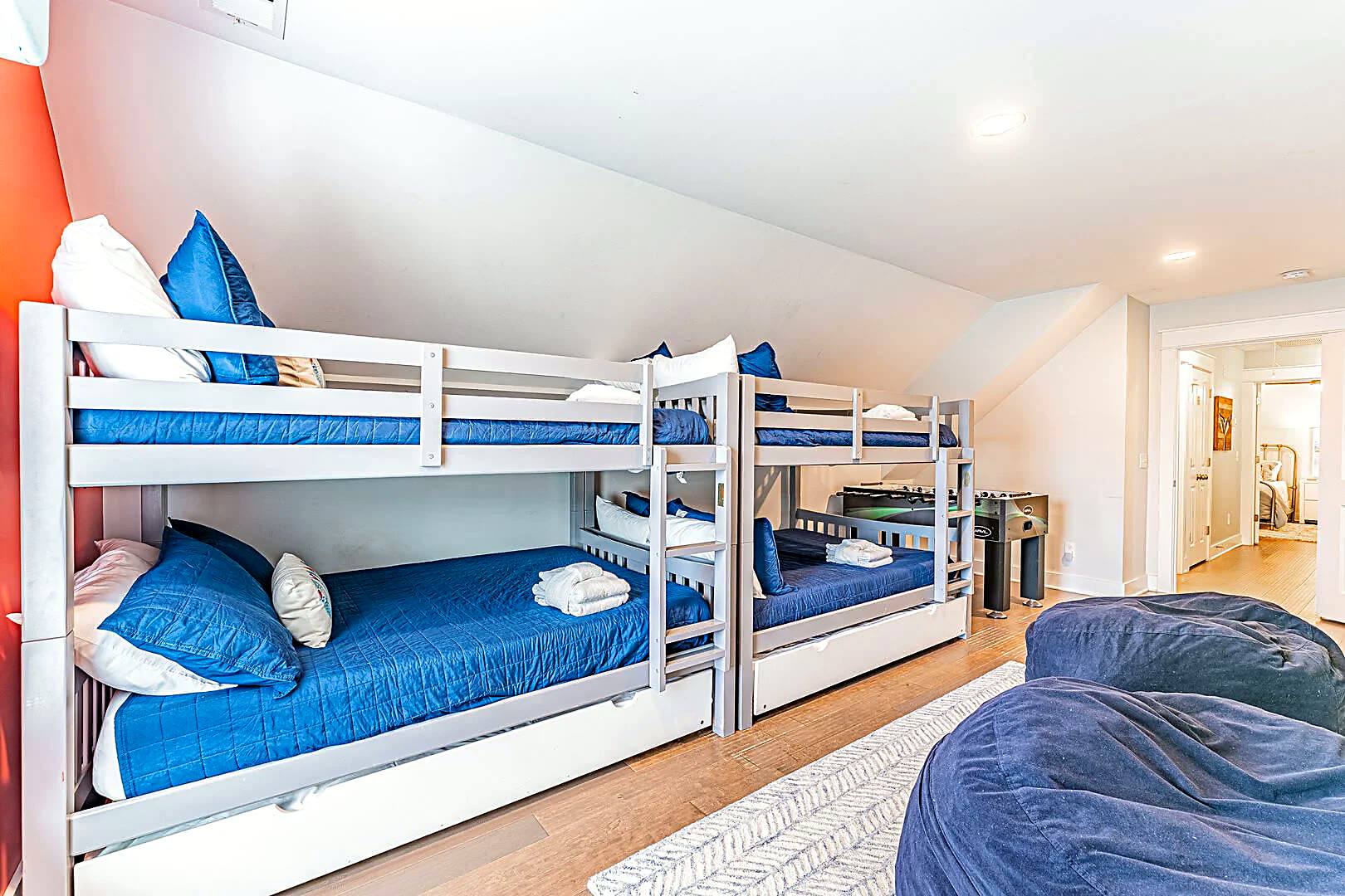 Two bunk beds with trundles and a foosball table in the bunk room at 122 Sandcastle Court