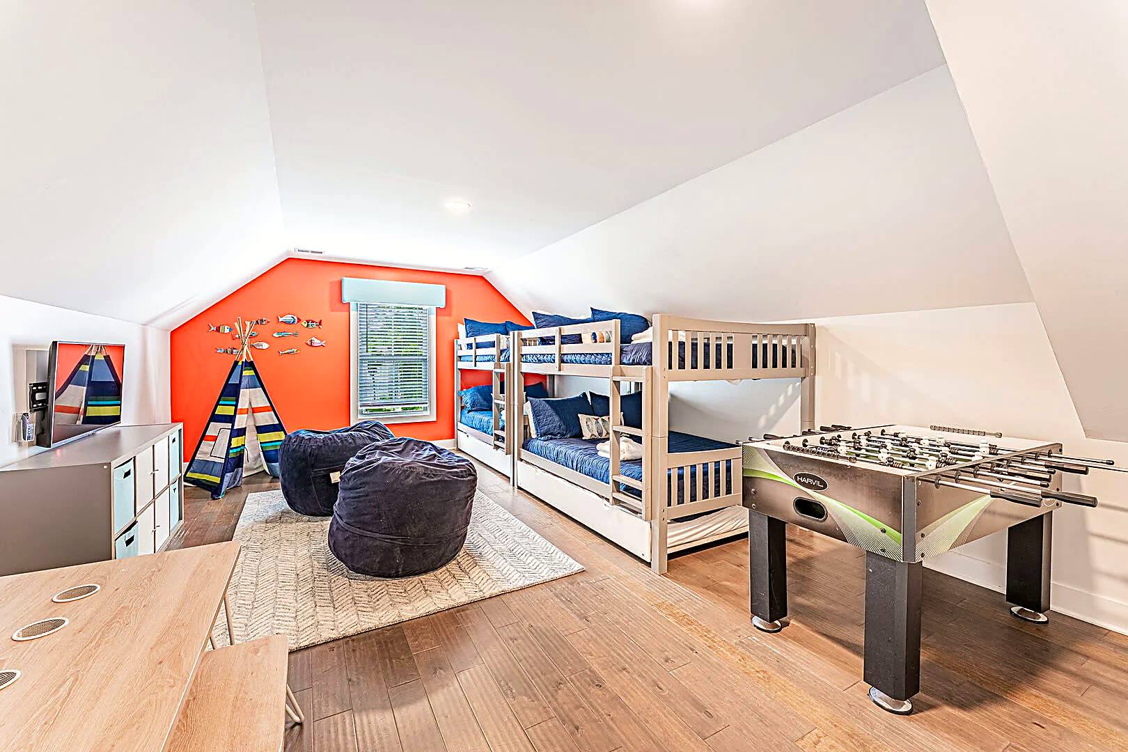 Kids' playroom at 122 Sandcastle Court with foosball table, beanbags, teepee and bunk beds